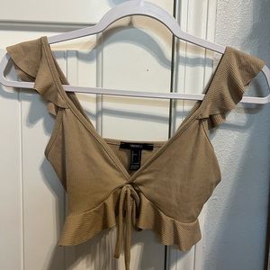 this tan crop top has never been worn.